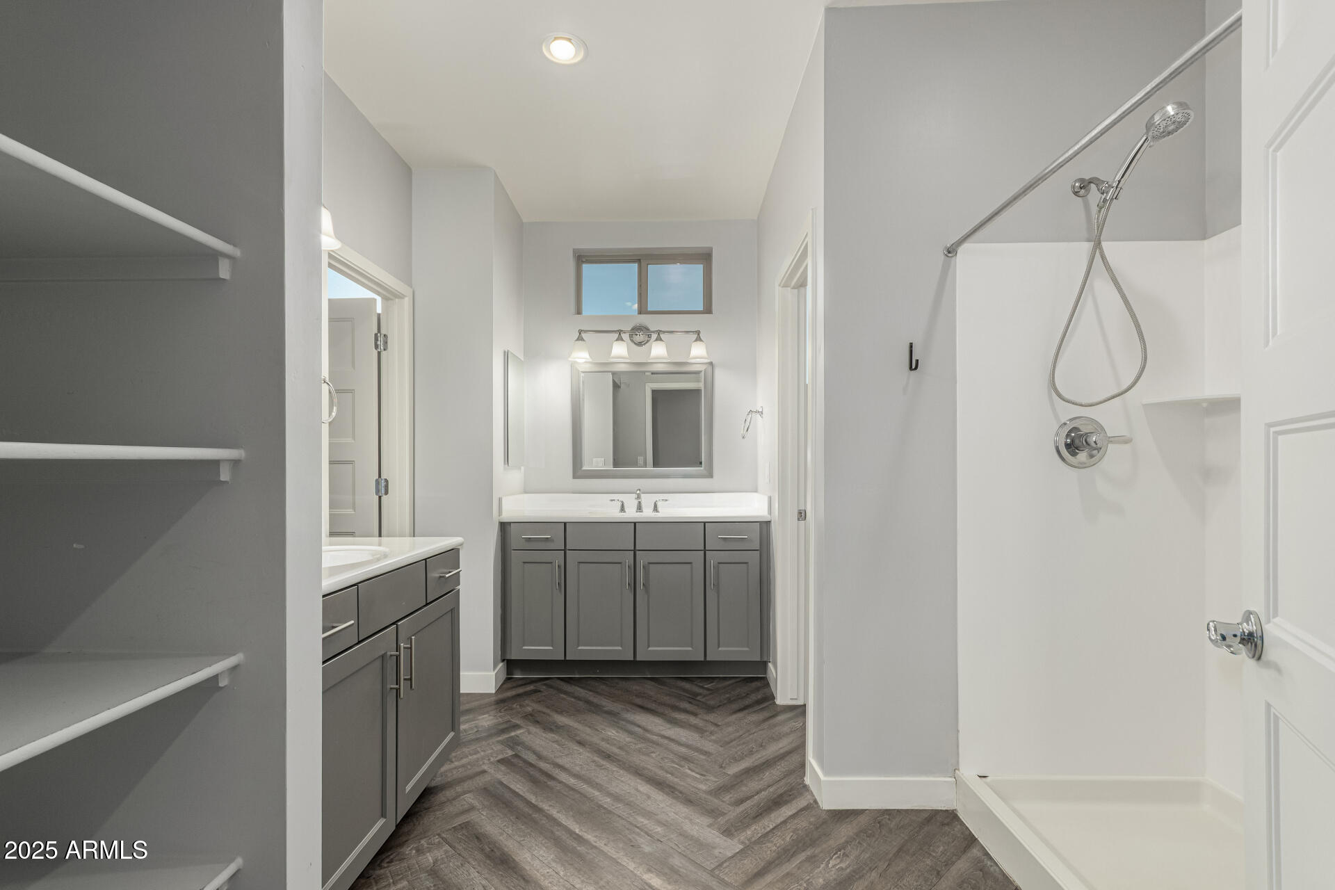 1056 North Miller Road Tempe, AZ 85288 - Photo 9 of 46 a bathroom with a double vanity sink a mirror and a shower
