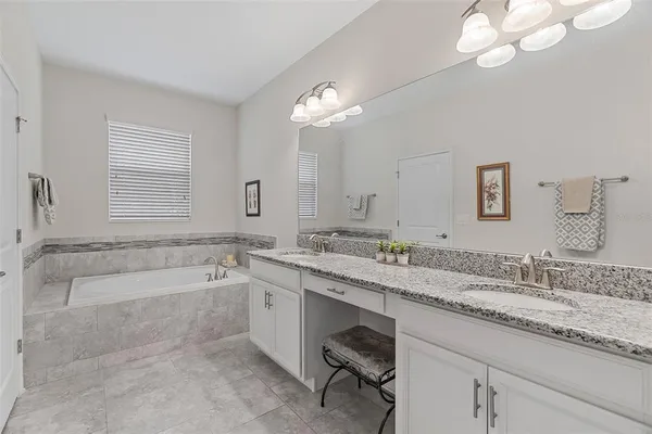 a living room with furniture a window and a chandelier