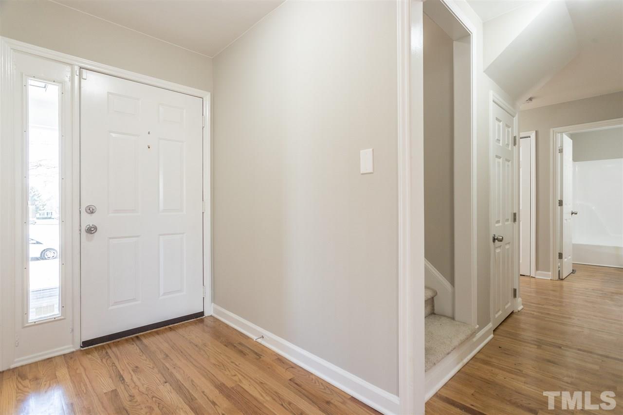 4556 Birmingham Way Raleigh, NC 27604 - Photo 11 of 24 a view of a hallway with wooden floor