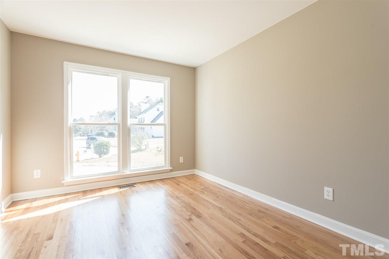 4556 Birmingham Way Raleigh, NC 27604 - Photo 12 of 24 an empty room with wooden floor and windows