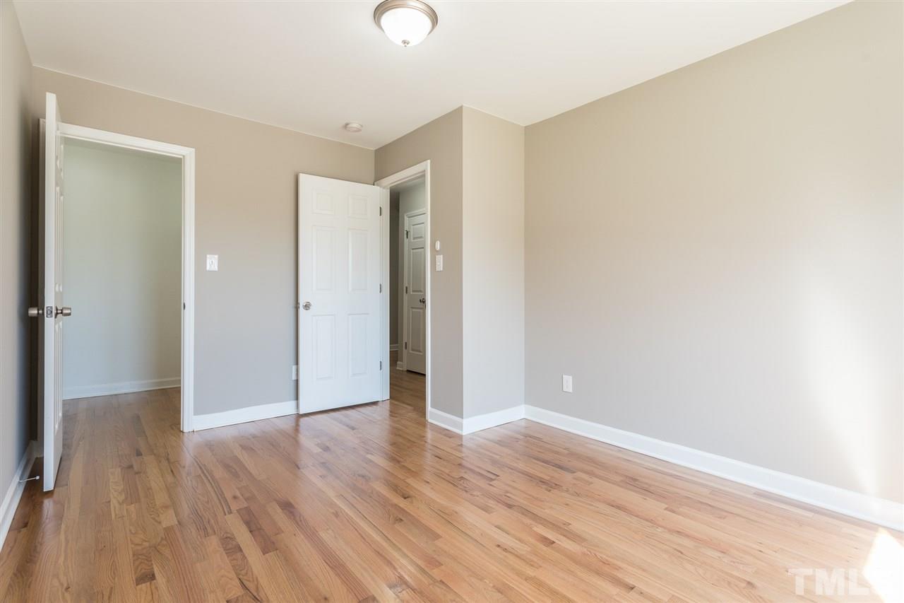 4556 Birmingham Way Raleigh, NC 27604 - Photo 14 of 24 a view of an empty room with wooden floor