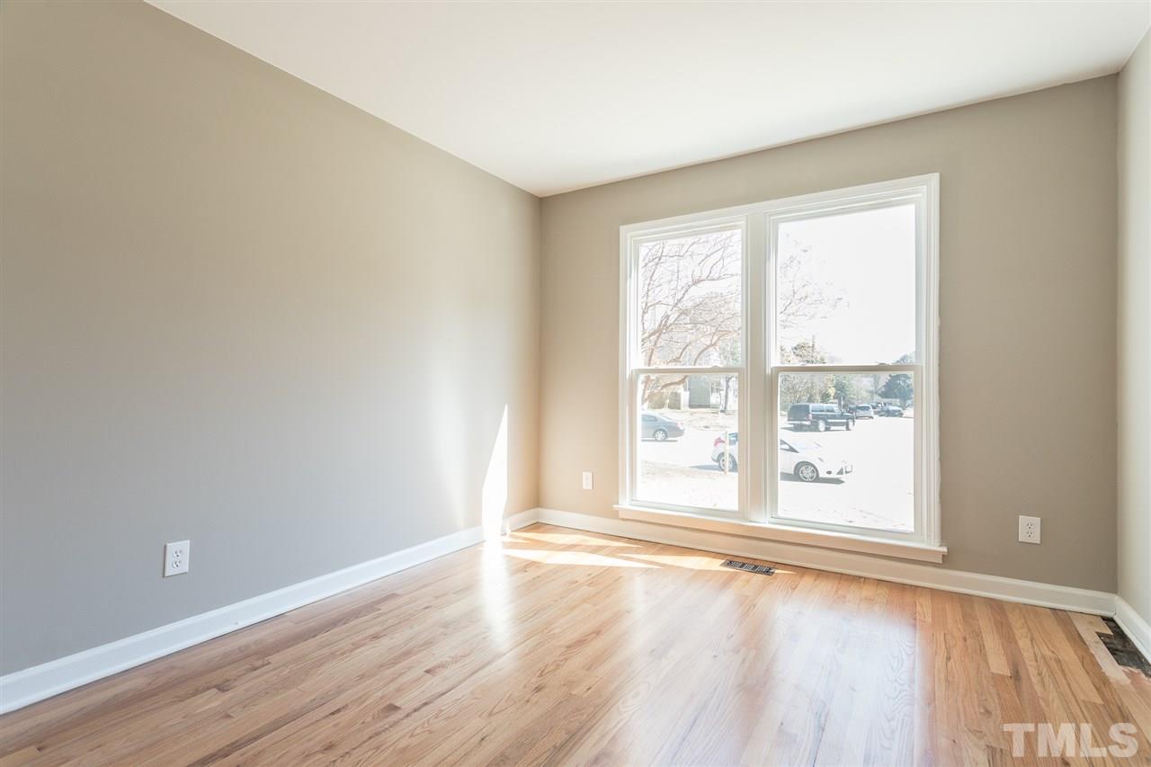 4556 Birmingham Way Raleigh, NC 27604 - Photo 15 of 24 an empty room with wooden floor and windows