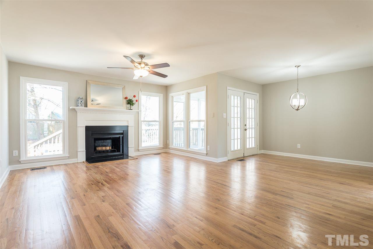 4556 Birmingham Way Raleigh, NC 27604 - Photo 3 of 24 wooden floor fireplace and windows in an empty room