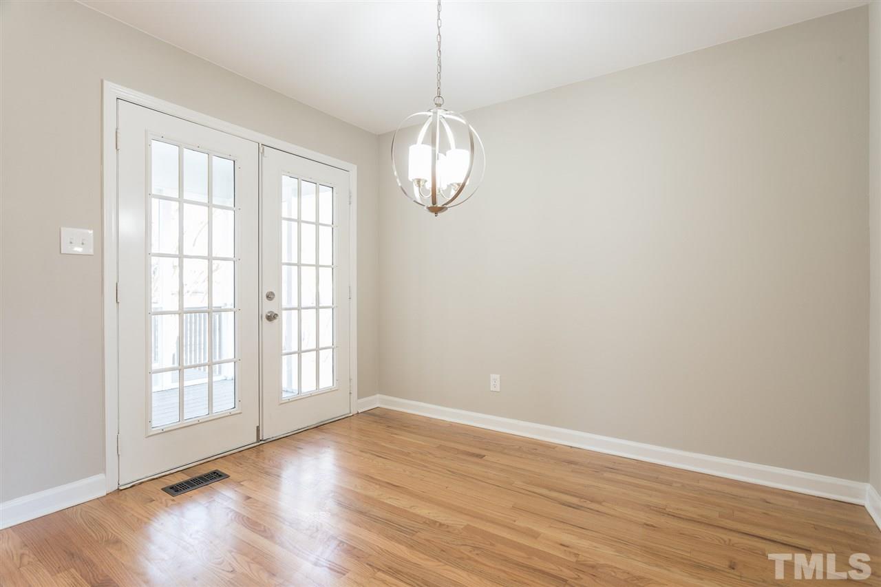 4556 Birmingham Way Raleigh, NC 27604 - Photo 4 of 24 wooden floor in an empty room with a window