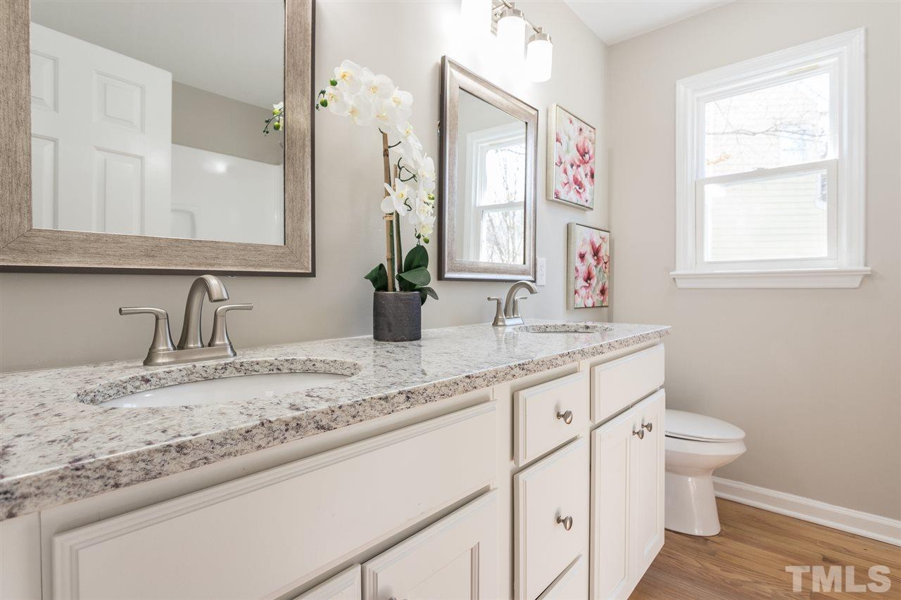 4556 Birmingham Way Raleigh, NC 27604 - Photo 6 of 24 a bathroom with a granite countertop sink mirror vanity and toilet