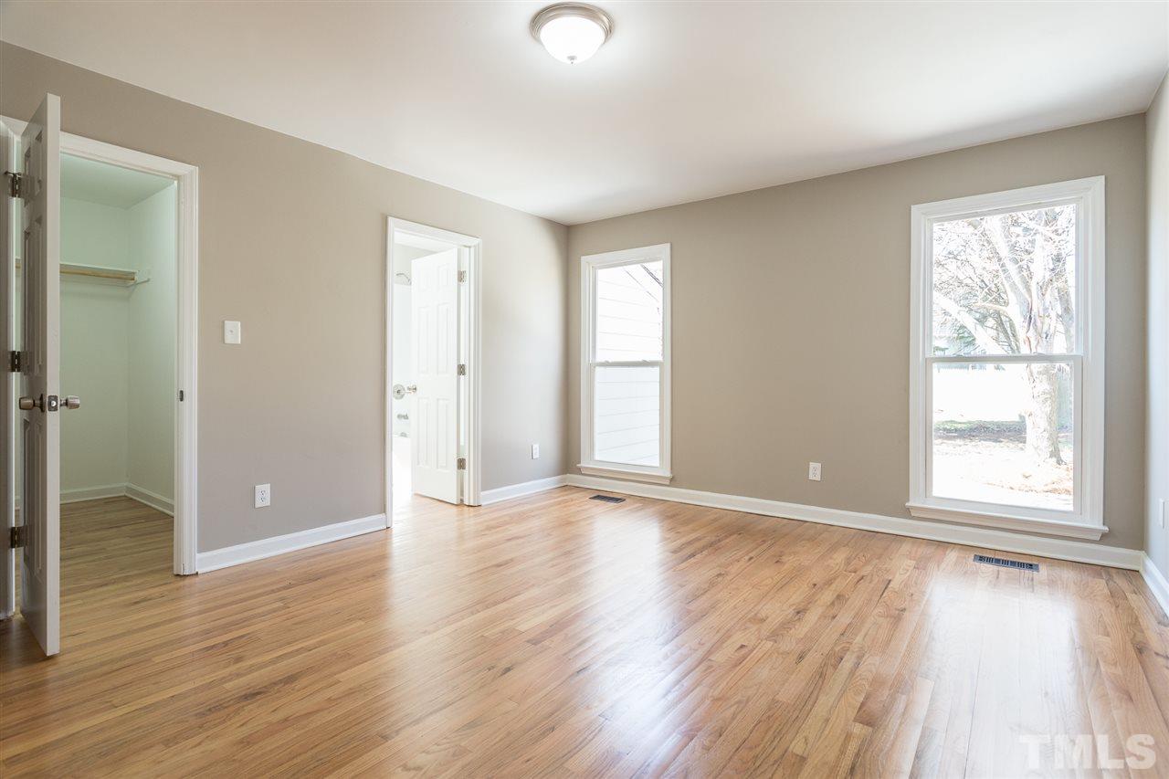 4556 Birmingham Way Raleigh, NC 27604 - Photo 10 of 24 a view of an empty room with window and wooden floor
