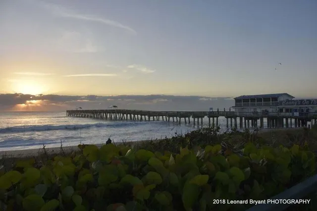 a view of a house with a yard and lake view