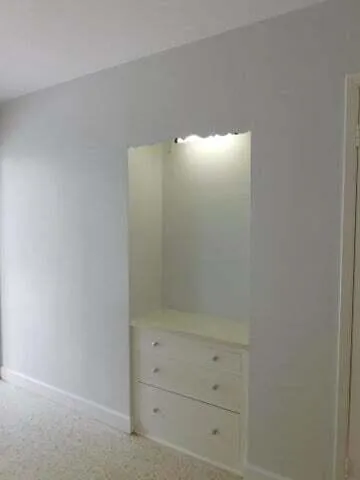 a kitchen with granite countertop a sink stove and cabinets