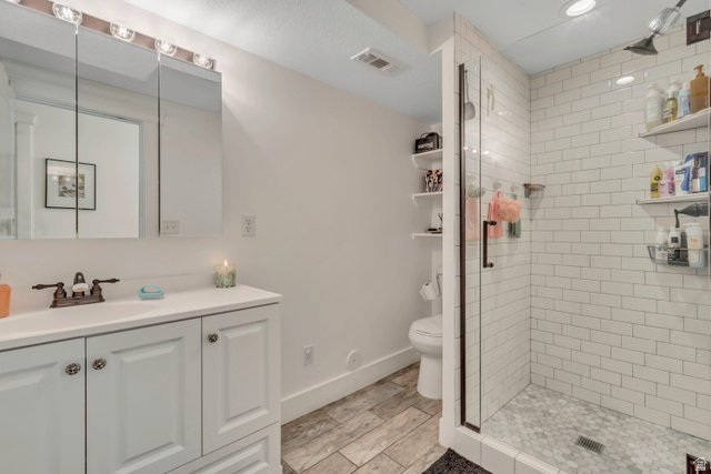 1071 Jamie-Matt Circle Layton, UT 84041 - Photo 11 of 28 Full bath with vanity, a shower stall, and wood tiled floors