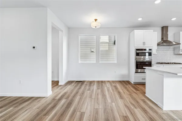 an empty room with cabinet and mirrors