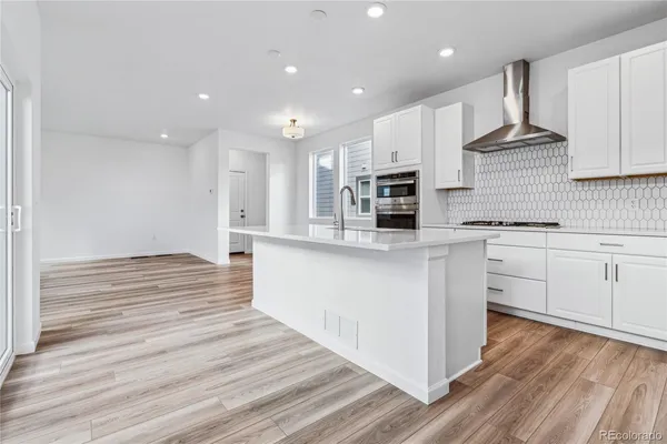 a view of a kitchen with wooden floor and a kitchen