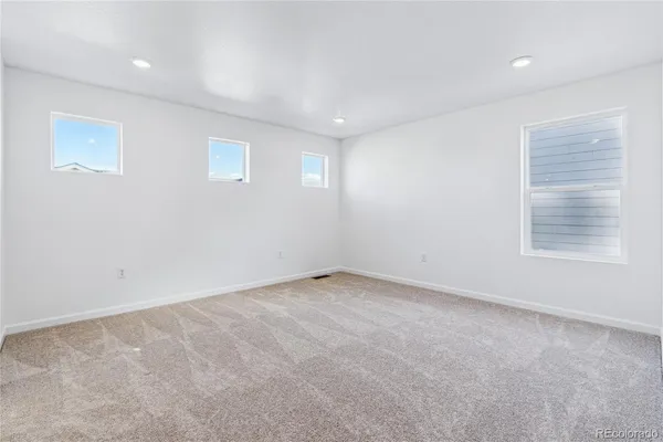 a spacious bathroom with a shower sink and mirror