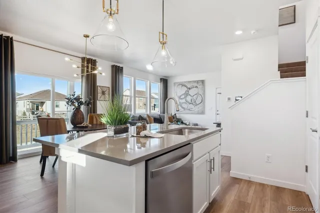 a kitchen with a sink a counter space appliances and cabinets