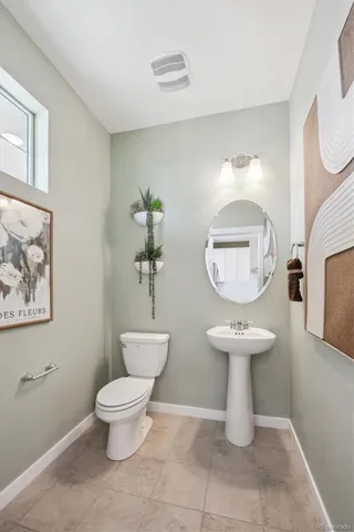 a large bathroom with a toilet and a mirror