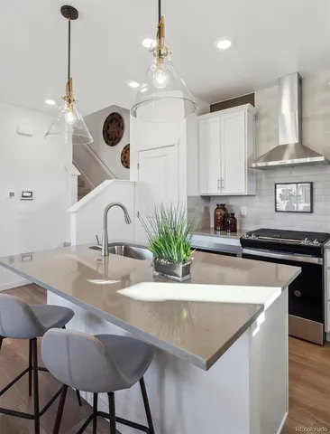 a kitchen with kitchen island granite countertop a sink a center island and cabinets