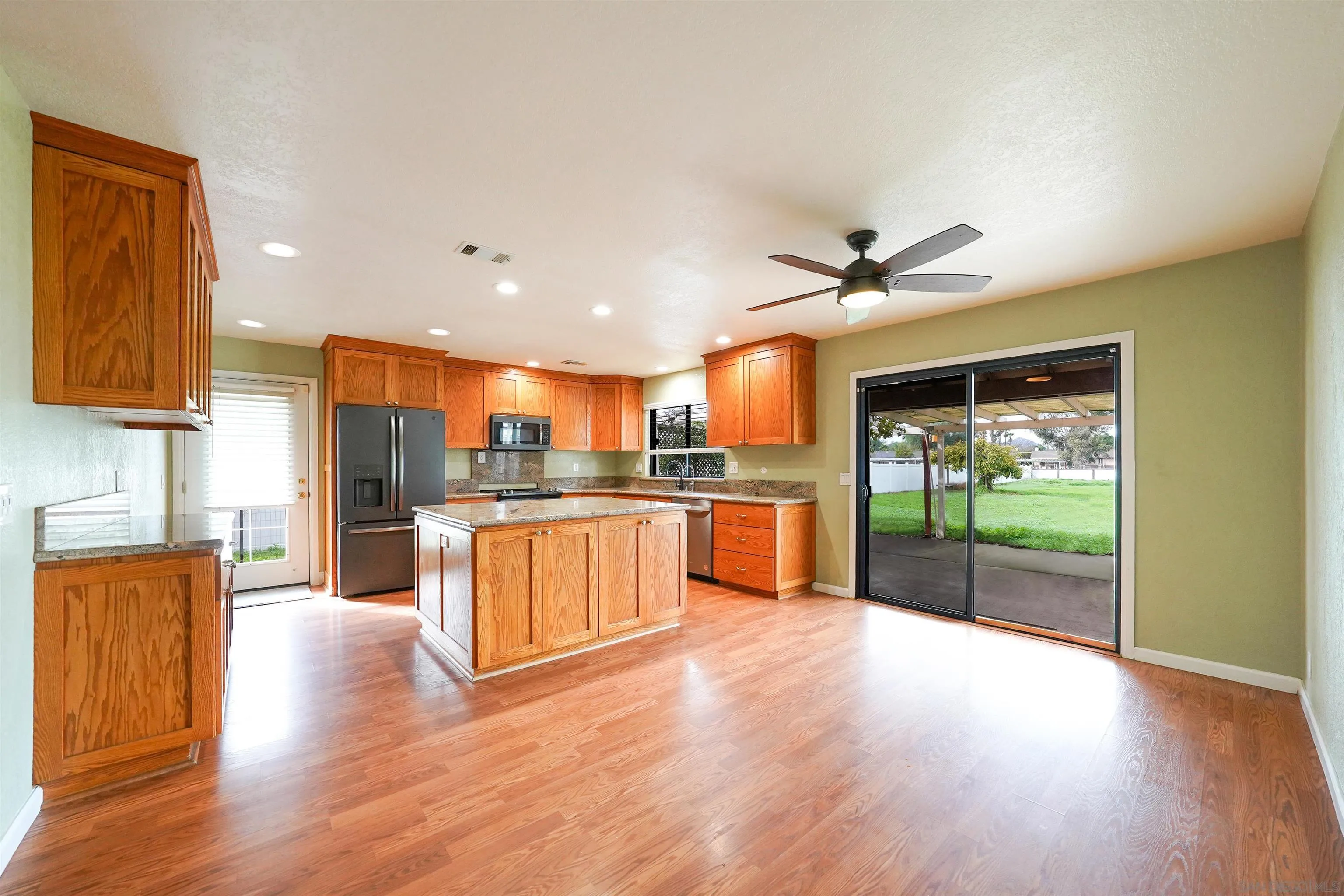 1465 Barnett Road Ramona, CA 92065 - Photo 17 of 43 a view of kitchen with refrigerator and wooden floor