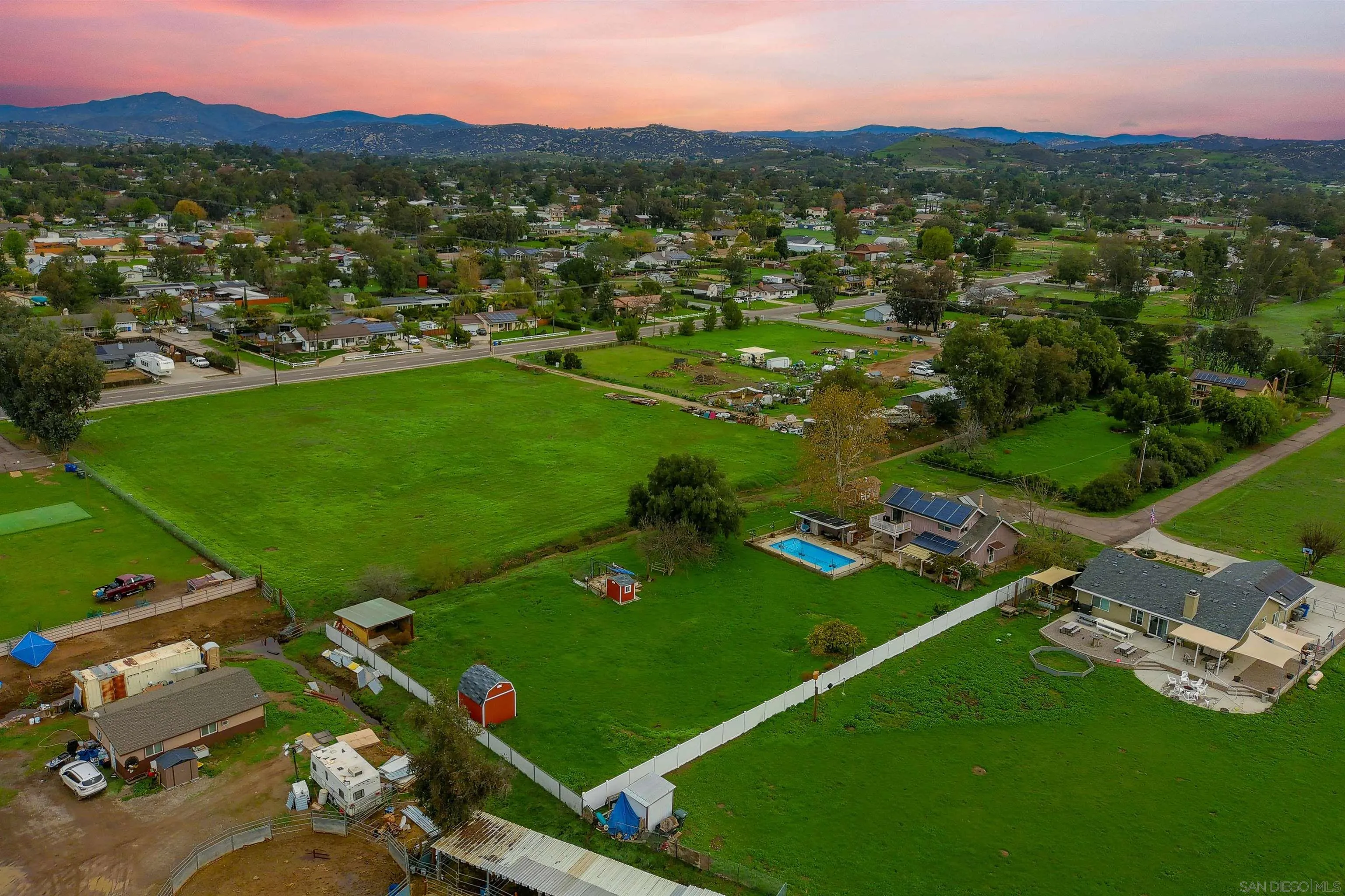 1465 Barnett Road Ramona, CA 92065 - Photo 5 of 43 an aerial view of green landscape with trees houses and mountain view