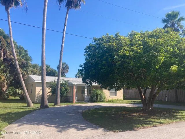 a view of a house with a tree in a yard
