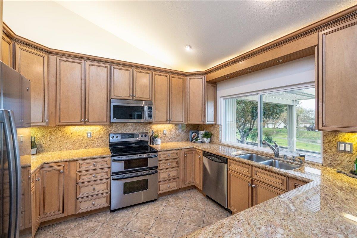 797 St George Road Danville, CA 94526 - Photo 11 of 52 a kitchen with stainless steel appliances granite countertop a stove a sink and a refrigerator