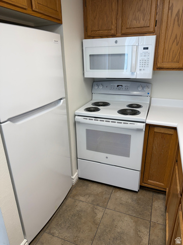 747 Hanover Drive Orem, UT 84058 - Photo 7 of 30 Kitchen featuring white appliances, wood finish cabinets, and light countertops