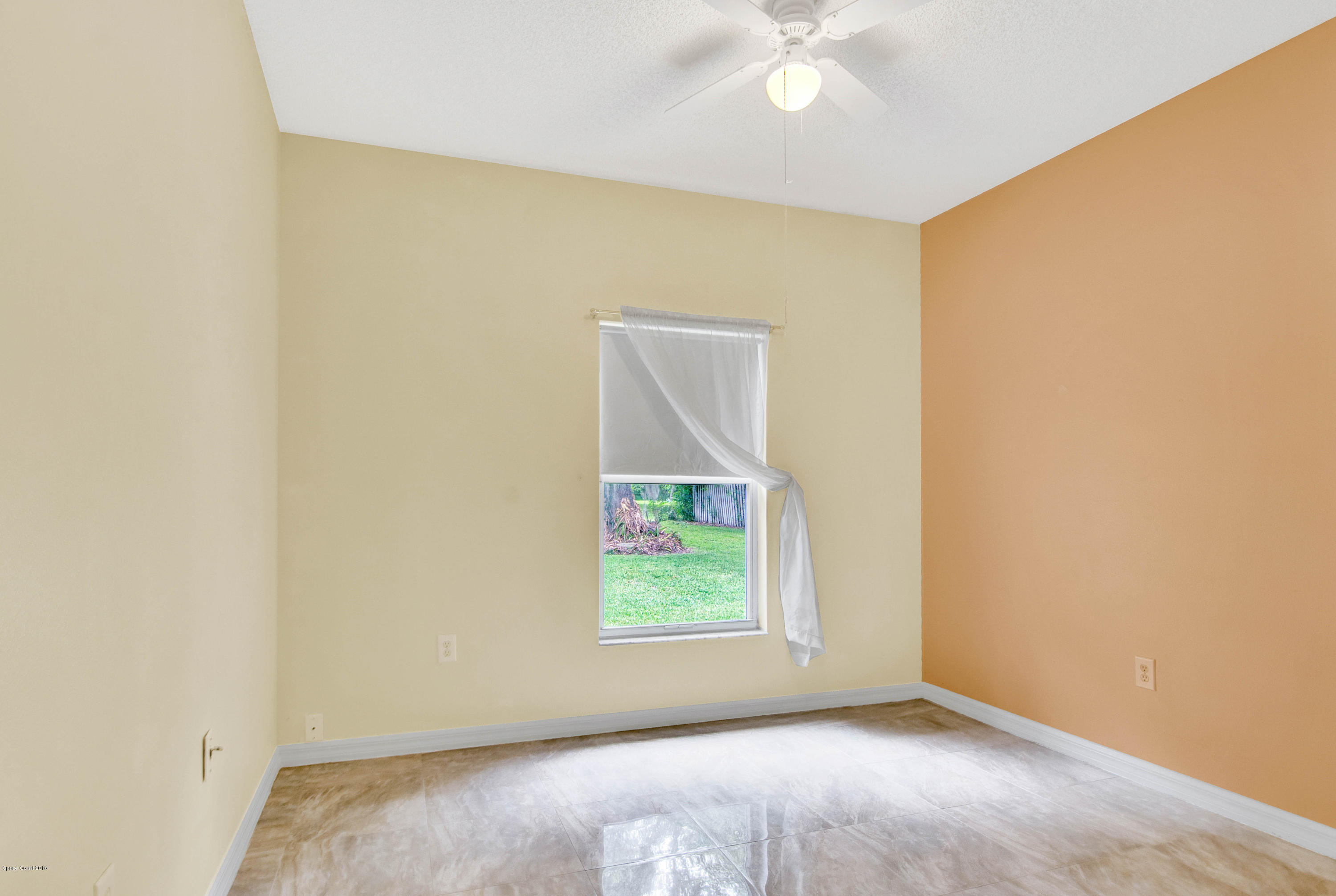 1030 Meadowbrook Road Northeast Palm Bay, FL 32905 - Photo 13 of 24 an empty room with a window