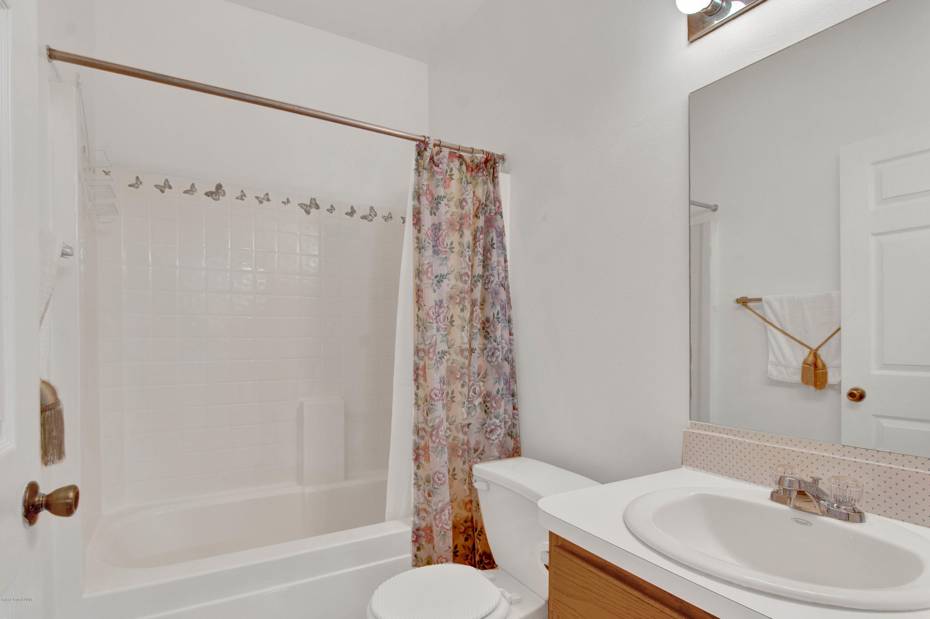 1030 Meadowbrook Road Northeast Palm Bay, FL 32905 - Photo 15 of 24 a bathroom with a sink a toilet and shower