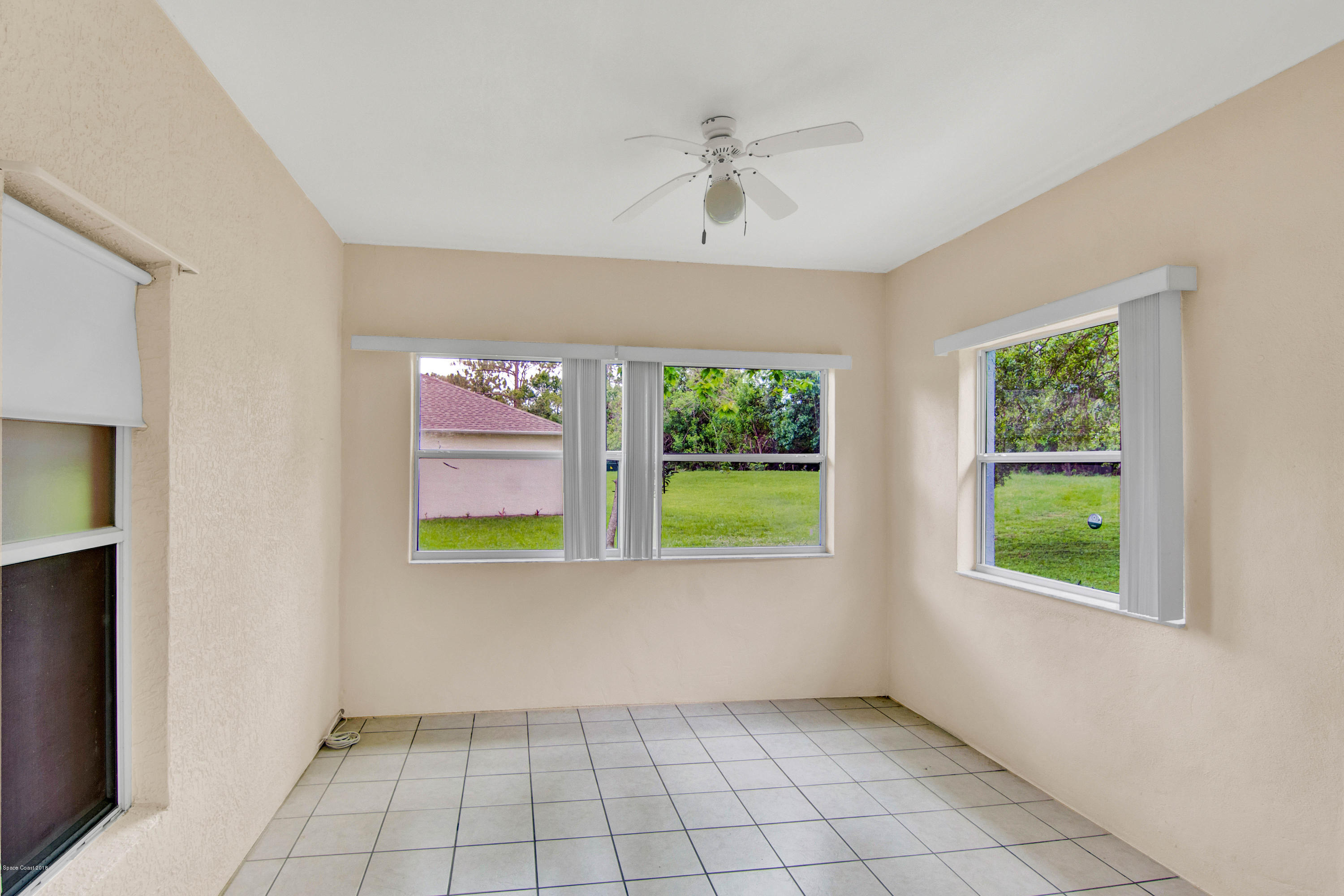 1030 Meadowbrook Road Northeast Palm Bay, FL 32905 - Photo 16 of 24 an empty room with windows