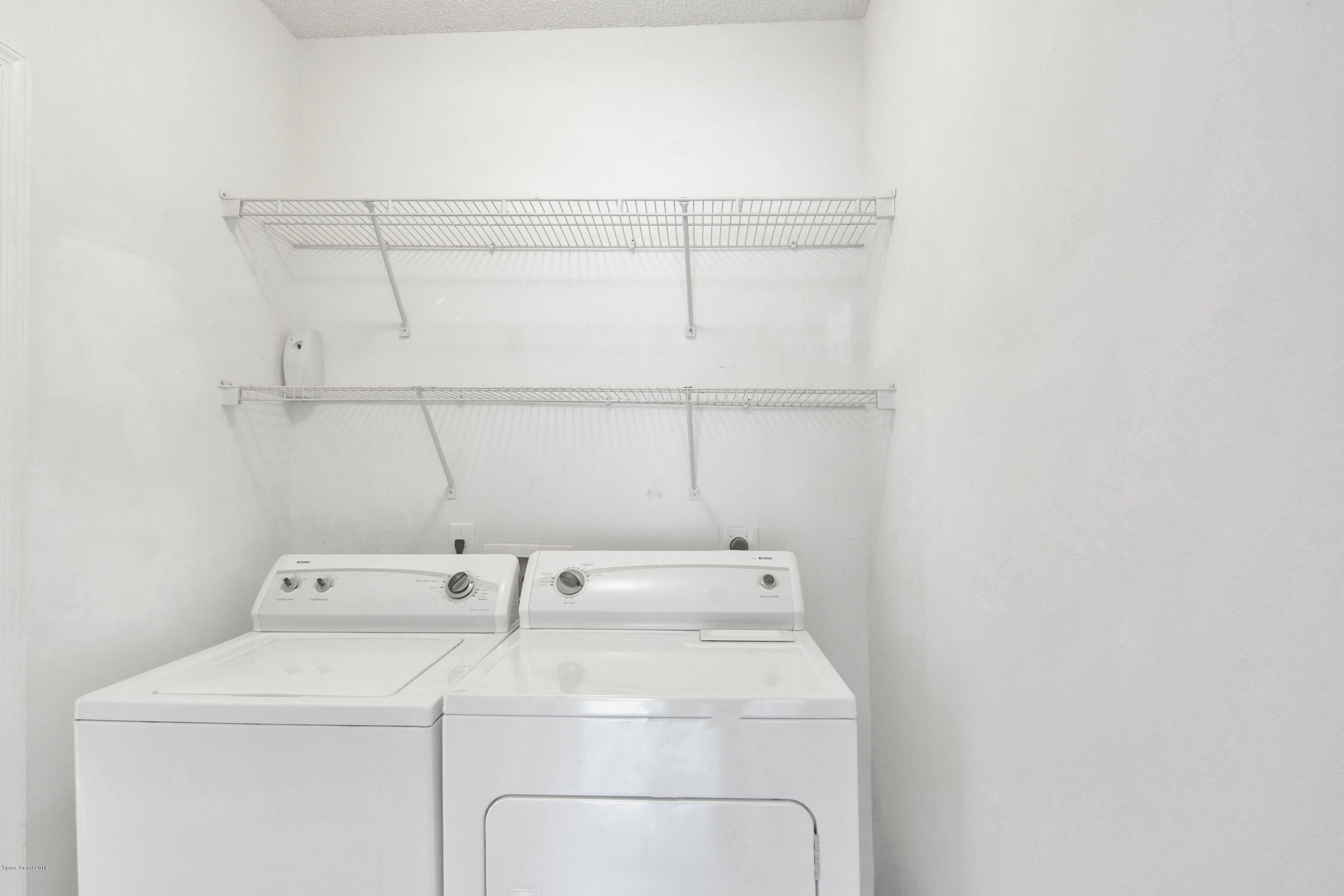 1030 Meadowbrook Road Northeast Palm Bay, FL 32905 - Photo 17 of 24 a utility room with dryer and washer