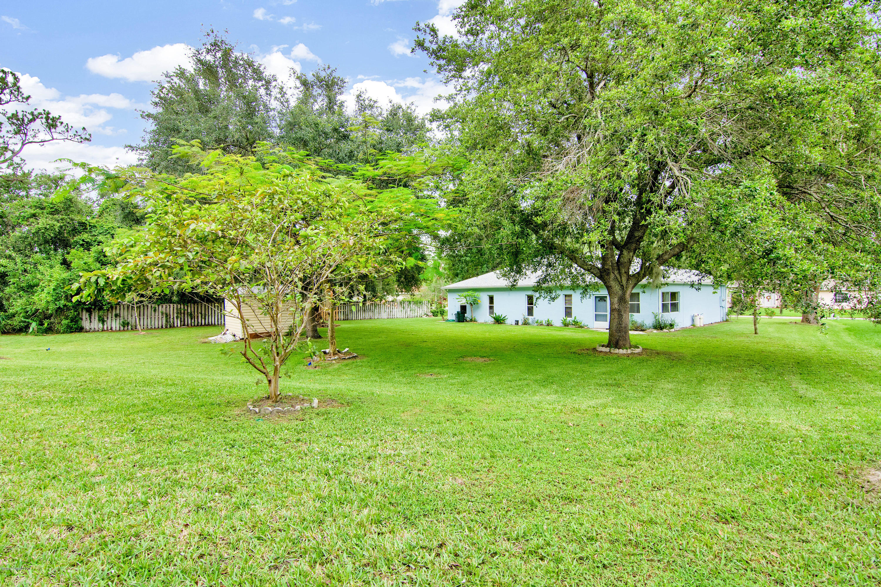 1030 Meadowbrook Road Northeast Palm Bay, FL 32905 - Photo 19 of 24 a huge green field with lots of trees
