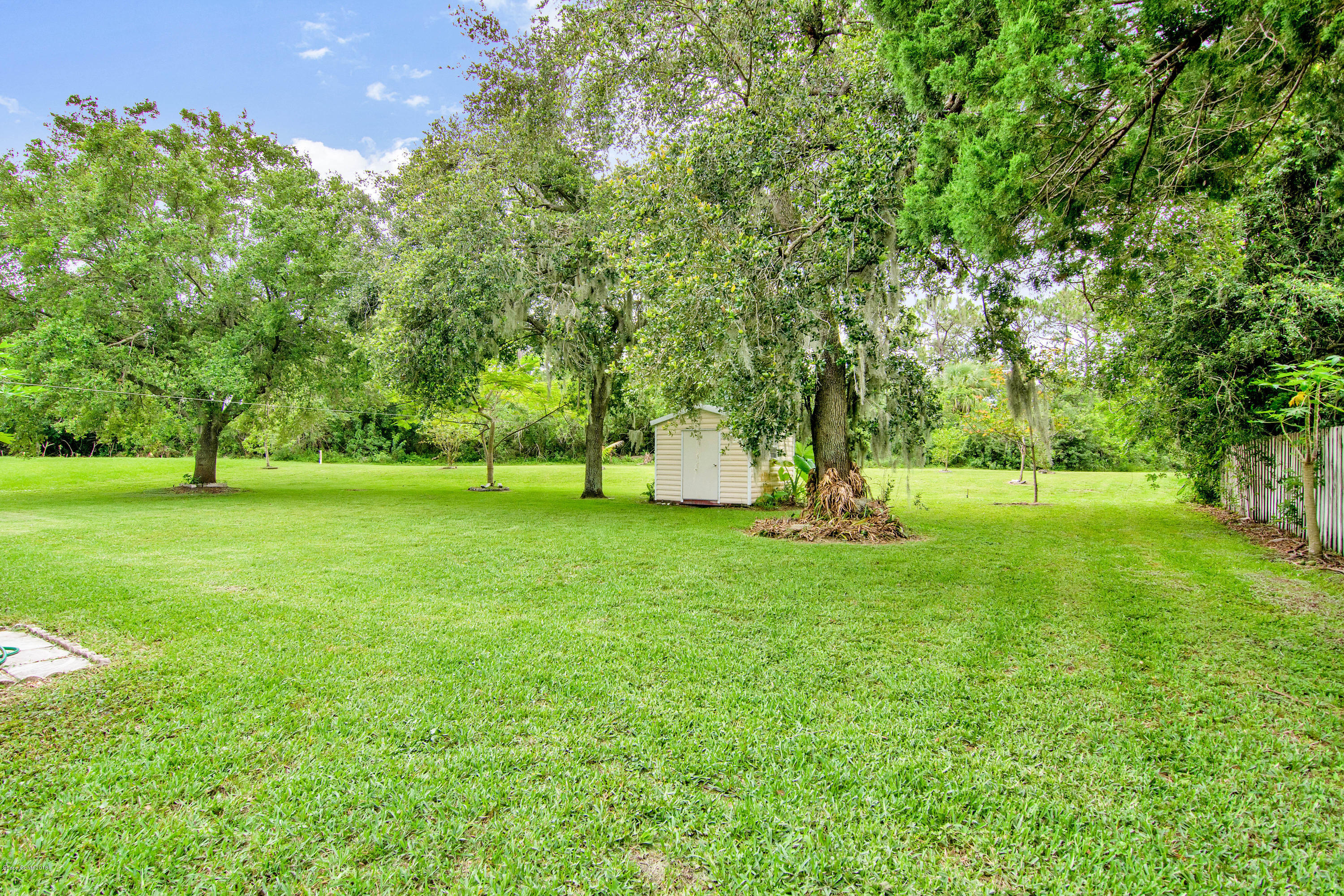 1030 Meadowbrook Road Northeast Palm Bay, FL 32905 - Photo 21 of 24 a view of outdoor space with deck and trees