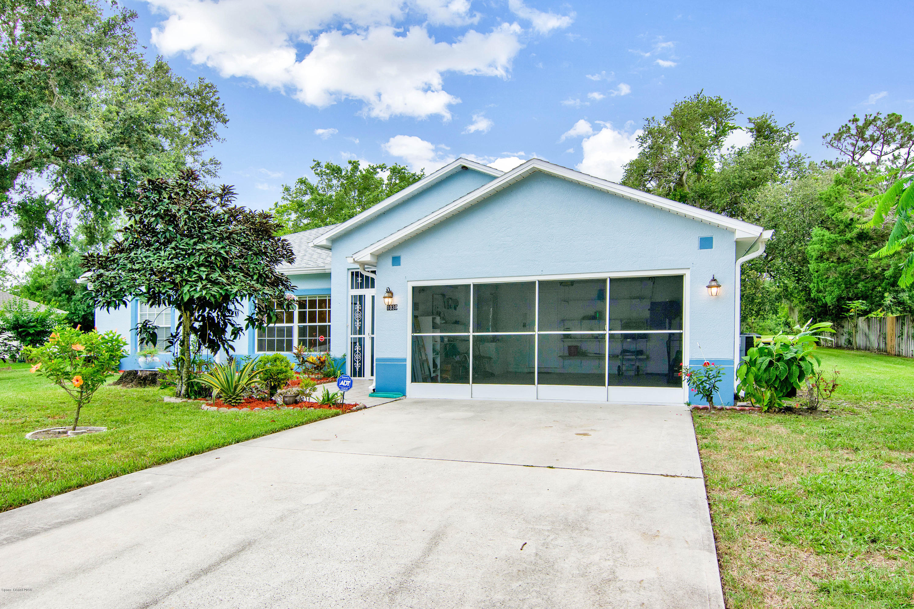 1030 Meadowbrook Road Northeast Palm Bay, FL 32905 - Photo 23 of 24 a house view with a garden space