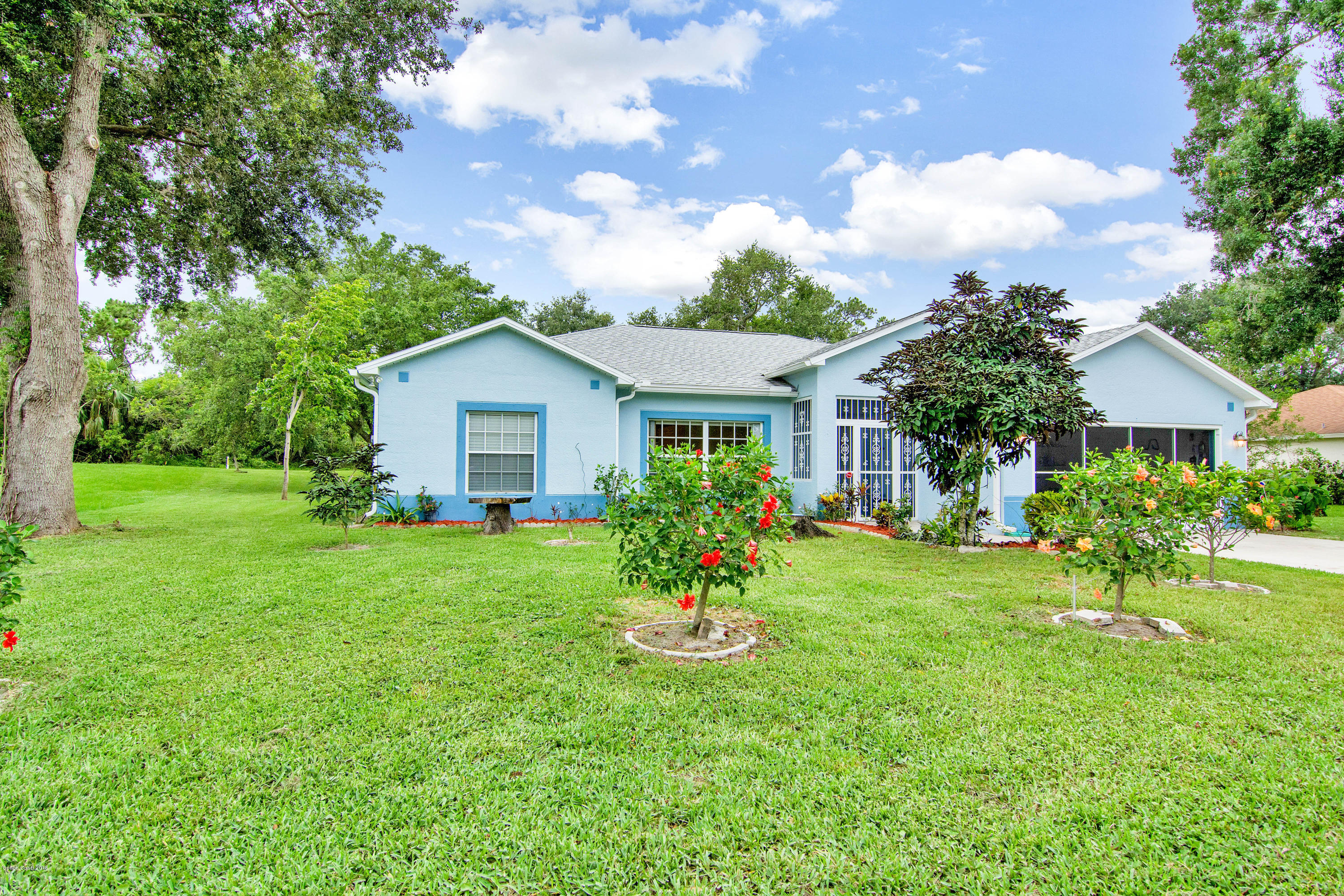 1030 Meadowbrook Road Northeast Palm Bay, FL 32905 - Photo 24 of 24 a view of a house with a yard and potted plants