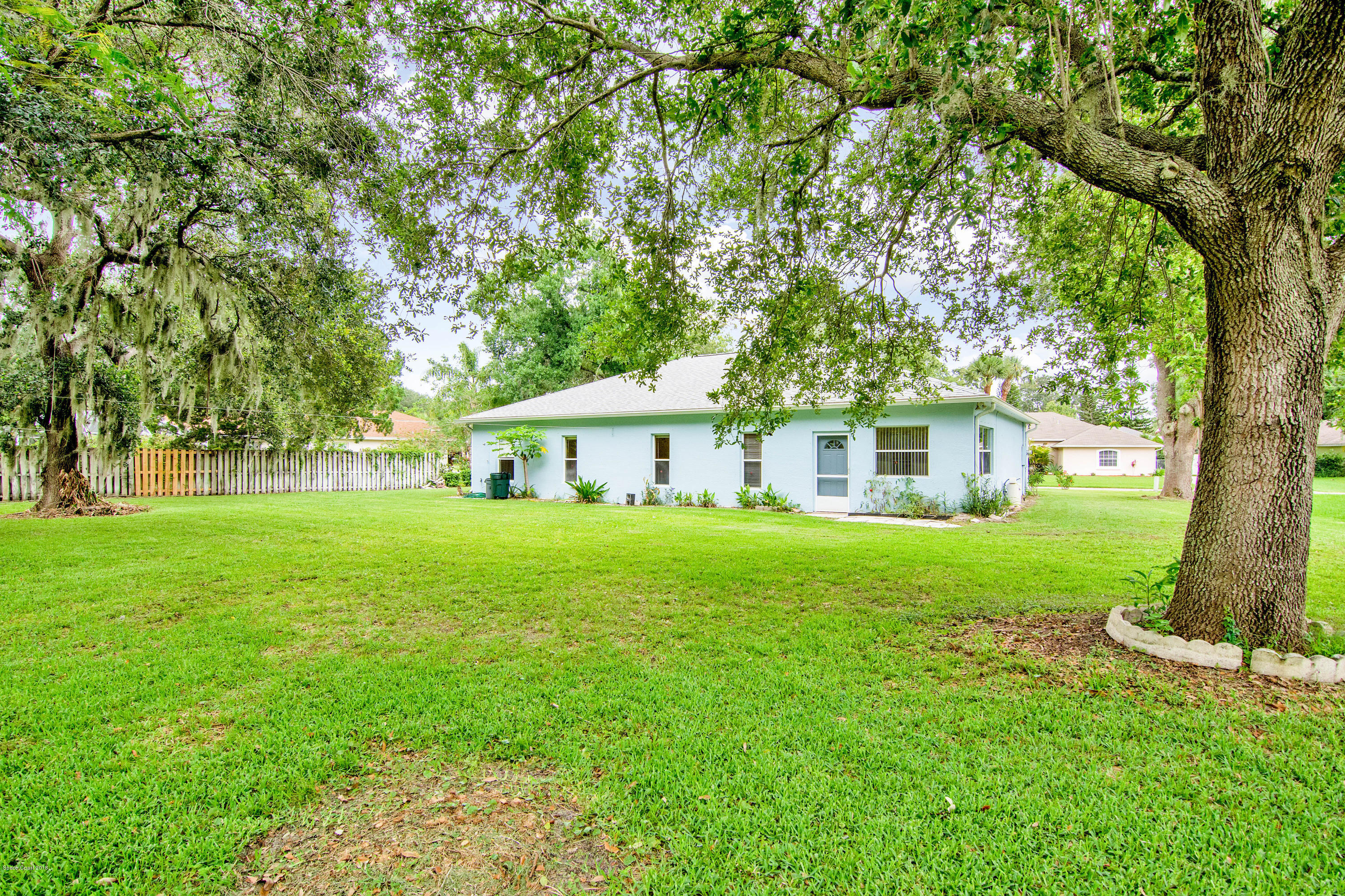 1030 Meadowbrook Road Northeast Palm Bay, FL 32905 - Photo 5 of 24 a front view of a house with garden