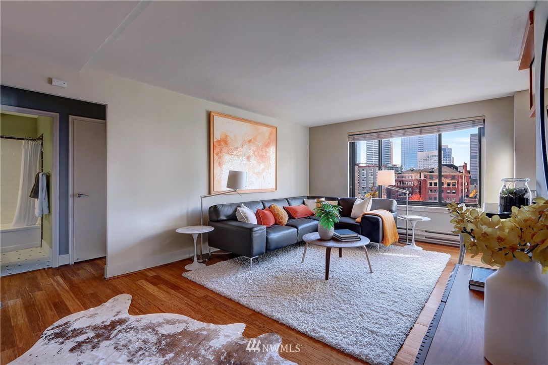 1105 Spring Street, Unit 610 Seattle, WA 98104 - Photo 5 of 12 a living room with furniture rug and window