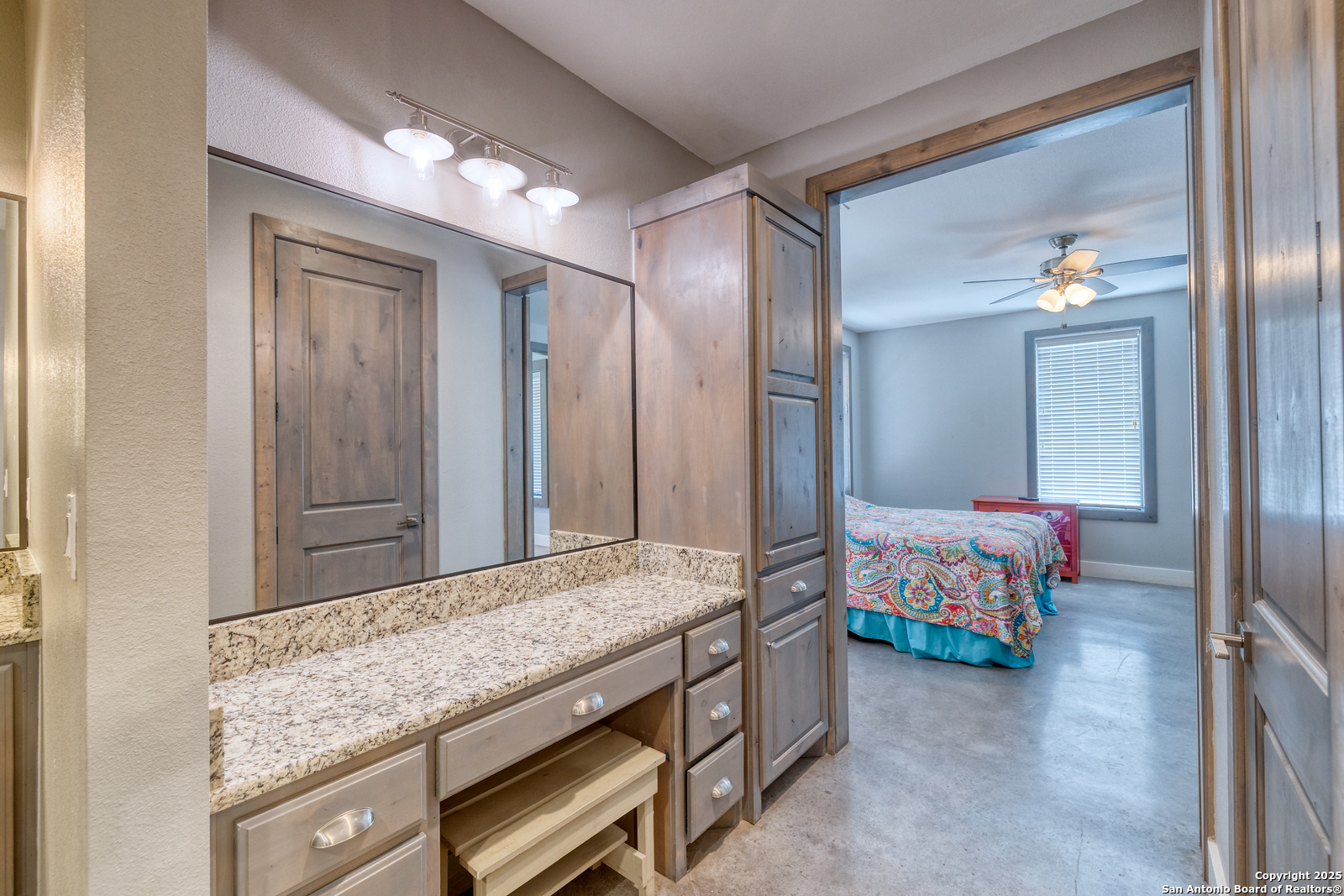 989 Mountain Valley Road Concan, TX 78838 - Photo 18 of 35 a spacious bedroom with a bed and a dresser