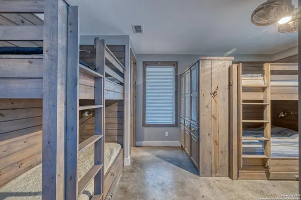 a bathroom with a granite countertop sink a toilet a mirror and shower