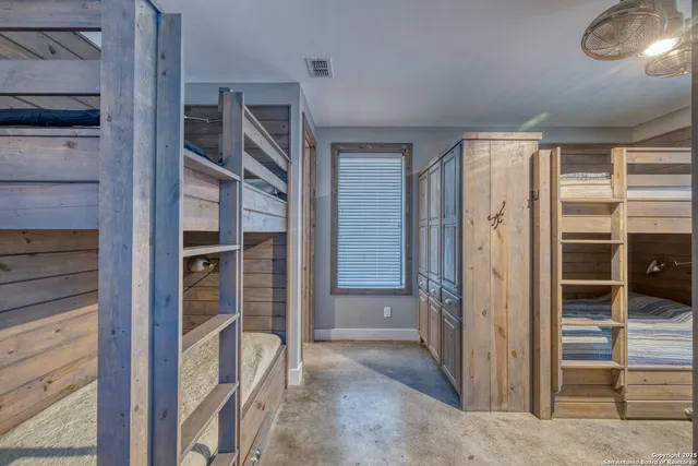 a bathroom with a granite countertop sink a toilet a mirror and shower