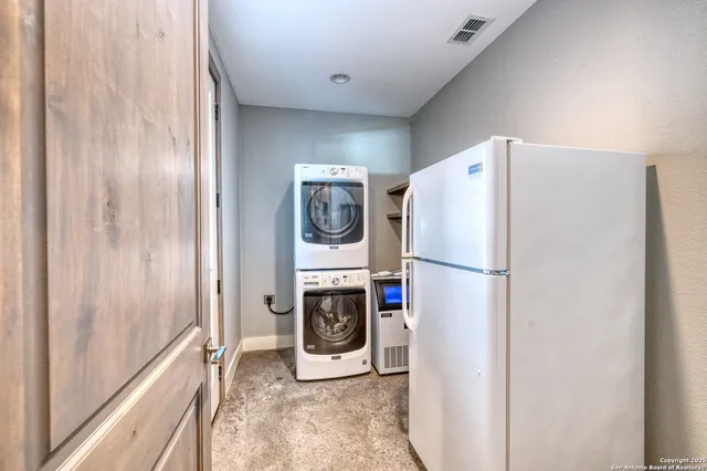 a view of a kitchen with kitchen island a large window cabinets and stainless steel appliances