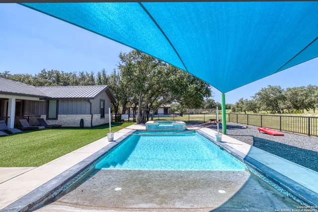 a view of swimming pool with an outdoor seating