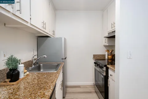 a kitchen with a refrigerator and a sink