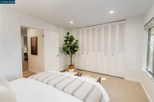 a bedroom with a bed and a potted plant