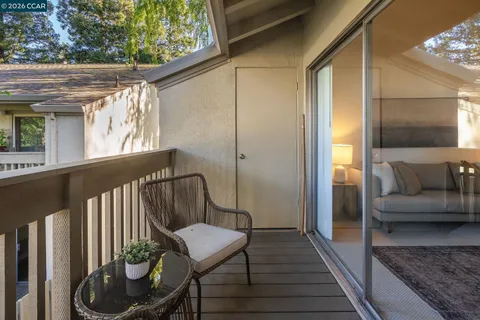 a view of a balcony with furniture
