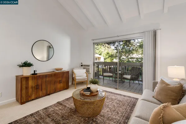 a living room with furniture and a floor to ceiling window