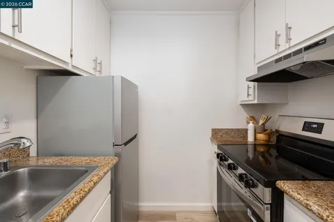 a kitchen that has a sink and a stove