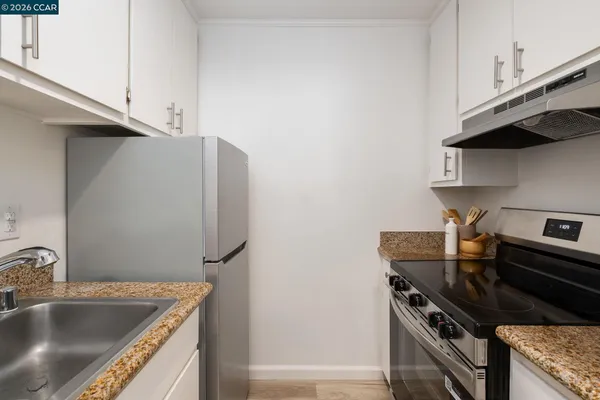 a kitchen that has a sink and a stove