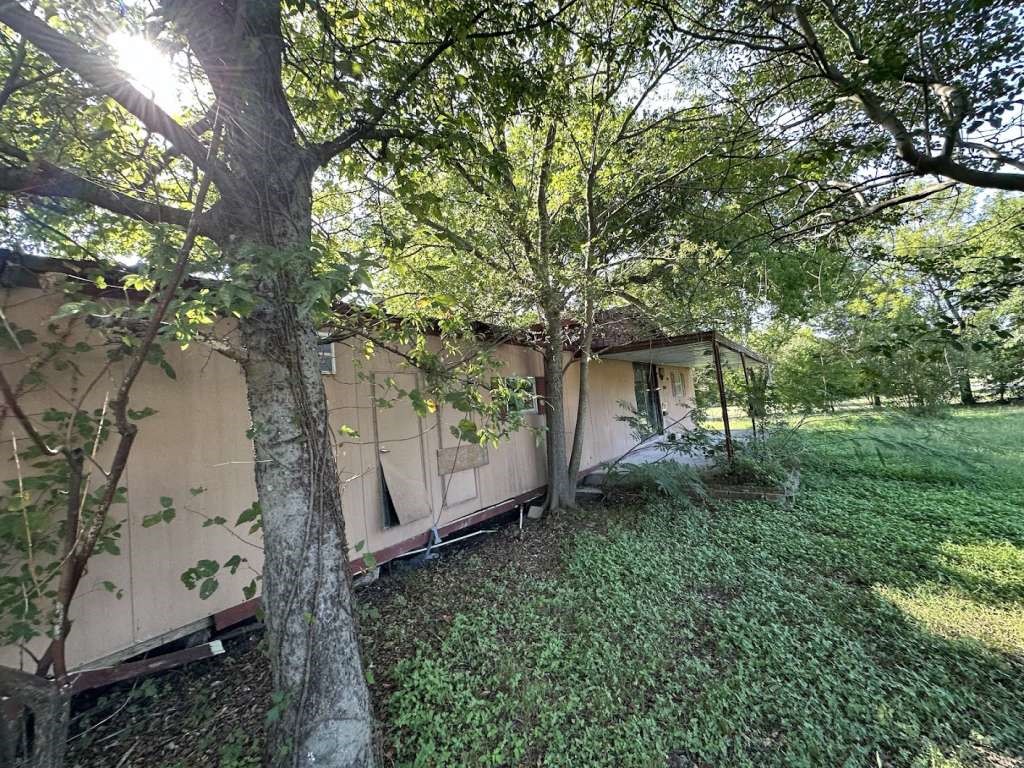 602 East Navasota Street Groesbeck, TX 76642 - Photo 2 of 13 a view of a house with a yard