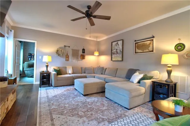 a living room with furniture and a lamp