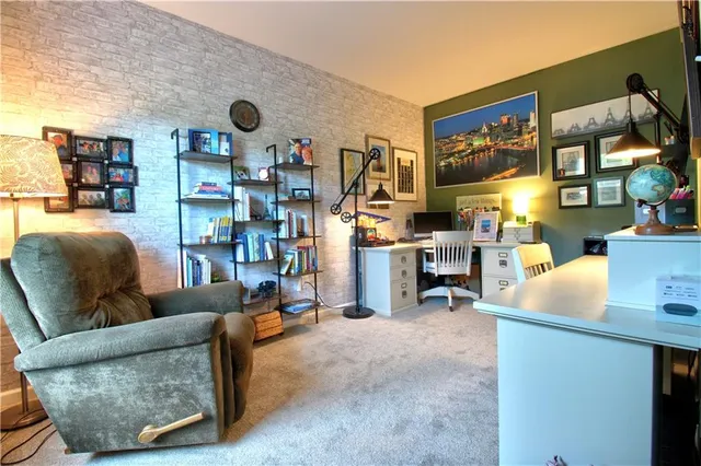 a living room with furniture and a bookshelf
