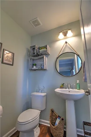 a bathroom with a toilet a sink and a mirror