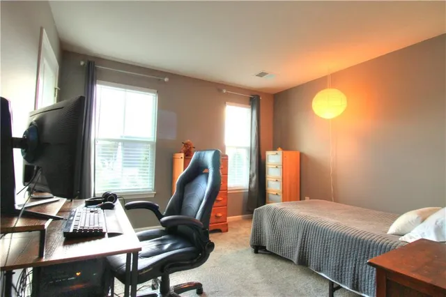 a bedroom with a bed and a desk